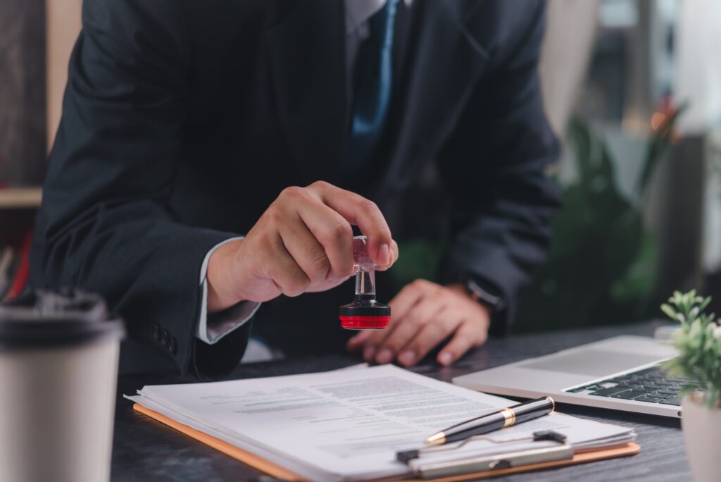 Business professional stamping a document,