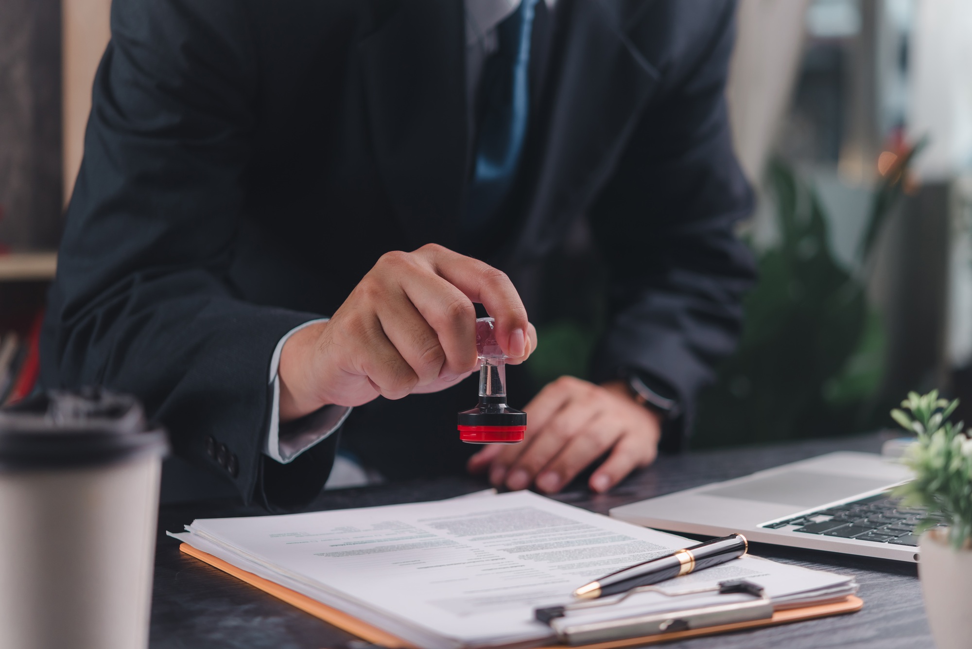 Business professional stamping a document,